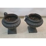 A PAIR OF BLACK PAINTED CAST IRON GARDEN URNS,