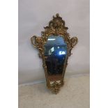 A GILTWOOD AND GESSO SHIELD SHAPED MIRROR,
