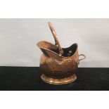 A COPPER HELMET SHAPED COAL SCUTTLE