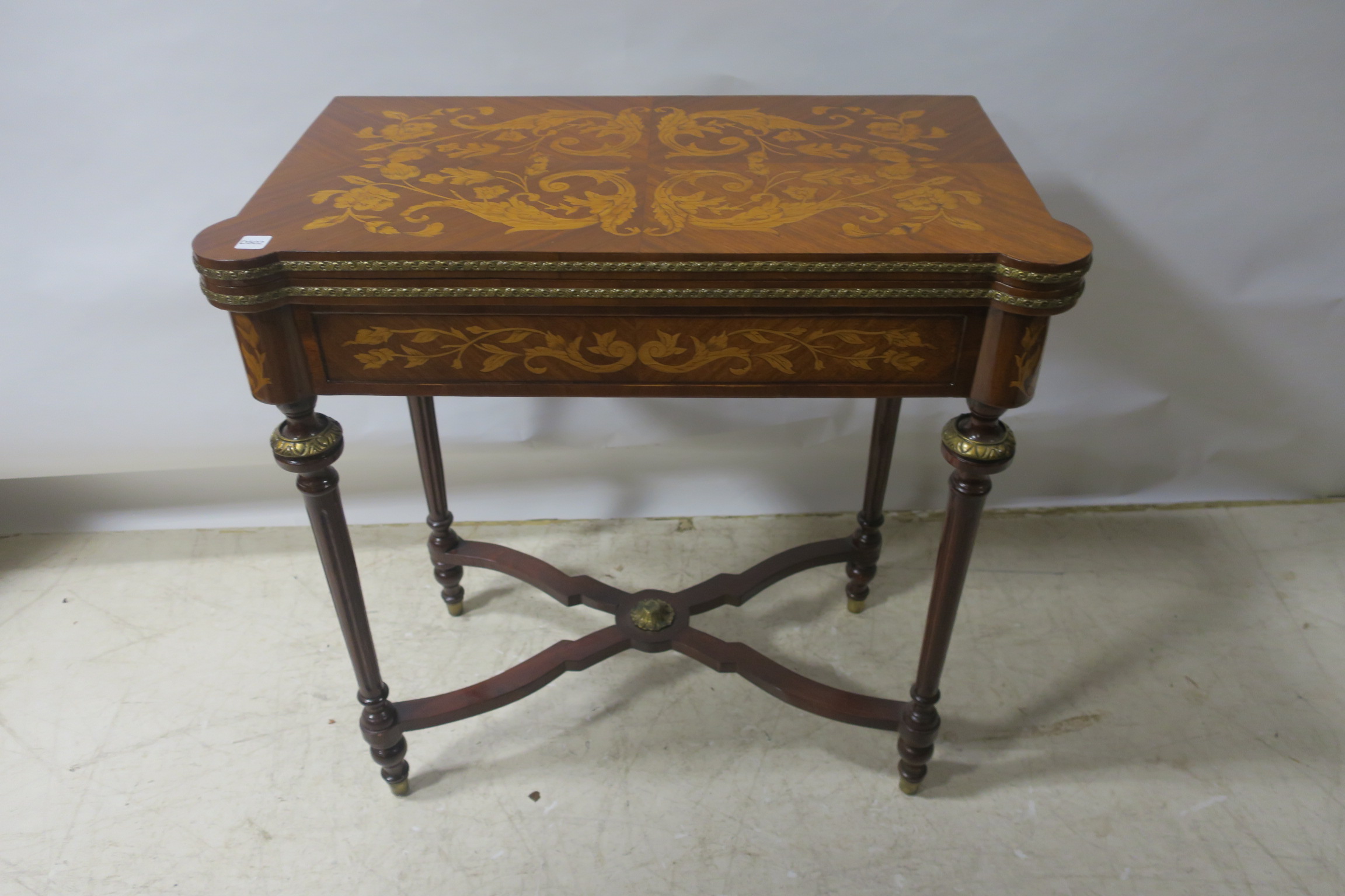 A CONTINENTAL KINGWOOD AND MARQUETRY INLAID FOLDOVER TOP GAMES TABLE,