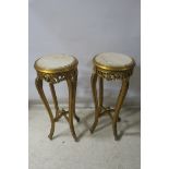 A PAIR OF GILT FRAMED PEDESTALS, of circular form with white marble inserts,