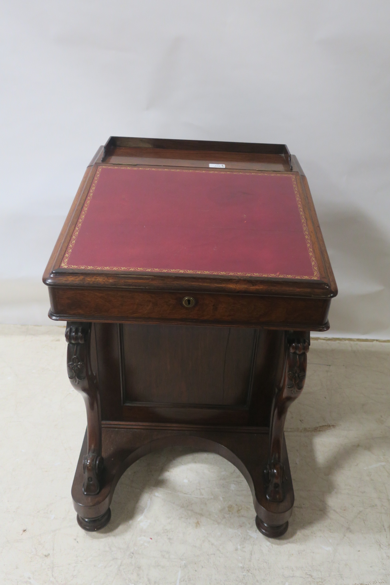 A FINE VICTORIAN ROSEWOOD DAVENPORT, the tooled, leather hinged writing slope,