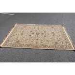 A BEIGE GROUND RUG,