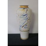 A GLAZED POTTERY VASE, of cylindrical tapering form, the white ground with painted scrolls,