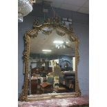 A CONTINENTAL DESIGN CARVED GILTWOOD OVERMANTLE MIRROR, of architectural form,