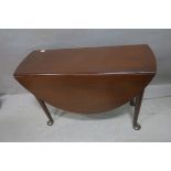 A FINE GEORGIAN MAHOGANY DROP LEAF TABLE the oval top raised on cabriole legs with pad feet