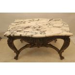 A CONTINENTAL CARVED GILTWOOD AND MARBLE TOP TABLE,