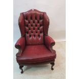 A GEORGIAN DESIGN HIDE UPHOLSTERED WING CHAIR,
