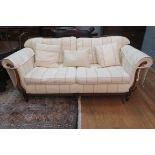 A CHERRYWOOD AND UPHOLSTERED SETTEE,