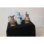 A PAIR OF CONTINENTAL JUGS, each of ovoid form with brass handles raised on a pierced brass base,