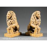Pair of Carved Sienna Marble Seated Lions, each with one paw resting atop a tablet, h. 9 1/4 in