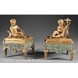 Pair of French Bronze Figural Chenets, each cherub holding an attribute of Hermes, h. 9 3/4 in.,