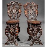 Pair of Italian Renaissance Carved Walnut Hall Chairs, 18th c., figural and mask-carved back, molded