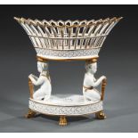 Paris Porcelain Figural Corbeille, navette-form reticulated basket, cupid supports, paw feet, h.