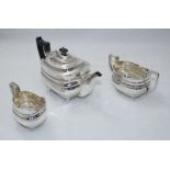 A three-piece silver tea set by 'William Hutton & Sons Ltd' comprising of a teapot, sugar bowl and