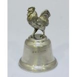 A silver bell modelled with a cockerel finial. 9cm high. Gross weight approximately 2.6oz. Hallmarks
