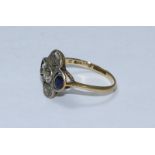 An 18ct gold and platinum ring of quatrefoil design, set with three Victorian cut diamonds, total