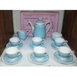 SECTION 28. A six-place Aynsley bone china coffee set decorated with scrolling foliage to a sky blue