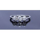 A platinum three stone diamond ring, claw set with Victorian cut diamonds. The diamonds being I in