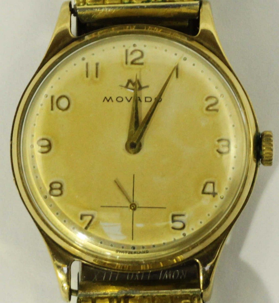 A gents 9ct gold Movado wristwatch, the silvered dial with Arabic numerals denoting hours and