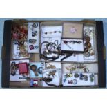 A large quantity of costume jewellery including some watches and various pin badges