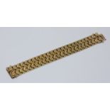A 9ct gold wide band bracelet with continuous design and safety clasp. 19.7cm long including