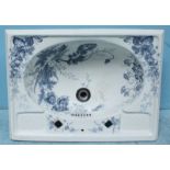 A blue and white floral printed wash basin with square tap holes