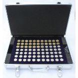 A metal briefcase housing five compartmented collectors trays of three-pence, six-pence,