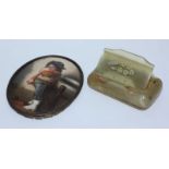 A 19th century painted porcelain oval portrait plaque of a young boy, approximately 9cm long,