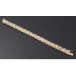 A 9ct gold bracelet, consisting of two rows of hearts, set with three hundred and four diamonds. The