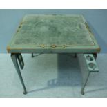 A turquoise painted card table, the top with velvet playing surface, floral decoration, fold out cup