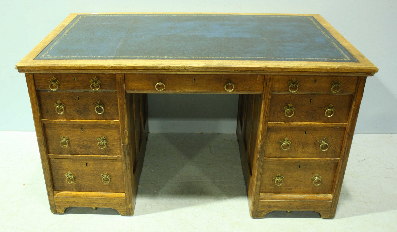 A 19th century oak pedestal desk in the Gothic Reform 'style' with gilt-tooled blue leather