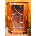 An Edwardian inlaid mahogany corner cupboard, with single glazed door enclosing a glass shelf, above