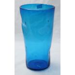 A tall blue glass vase of tapering cylindrical form with dimpled sides, approximately 33cm high