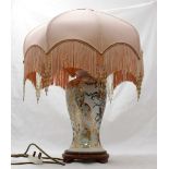 A ceramic table lamp of inverted baluster form, with gilt and floral decoration and raised on turned