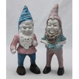 A pair of small cast iron garden gnomes. 28cm high.