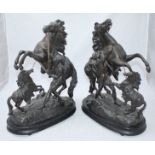 A pair of patinated spelter Marly Horses after Coustou, raised on ebonised-wooden bases. 43cm high.