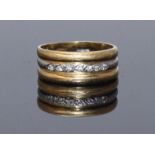 An Egyptian bi-colour 18ct gold ring, the central white gold band flush set with seven small