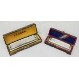 A cased Hohner Harmonica '64' together with a boxed Hohner 'Super Chromonica'.