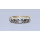 An 18ct gold ring, the top set with five Victorian cushion cut diamonds, total diamond weight