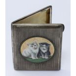 A silver cigarette case, the top decorated with a circular enamelled panel depicting two cats. 8.5 x