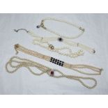 Five various pearl necklaces set with red, blue and diamante stones