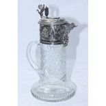 A cut glass claret jug with ornately worked silver-plated mount. 29cm high. (AF)