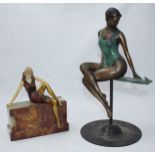 A simulated ivory and patinated metal cast figure of a lady, in the art deco 'style' modelled sat on