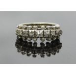 An antique white-metal diamond ring, set with twenty-five graduated Victorian Mine-cut diamonds,