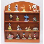A collection of approximately eighteen ceramic Disney figures including Dumbo, Genie, Minnie Mouse