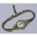 A ladies 9ct gold Rotary wristwatch, the silvered dial with batons denoting hours, on articulated