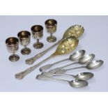 A set of four silver egg cups and five silver, fiddle pattern tea spoons, together with a pair of