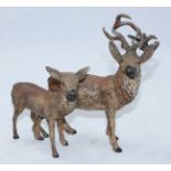 A late 19th century cold-painted hollow-cast spelter figure group of a deer and stag, 20cm long
