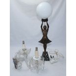 An Art Deco bronzed figural lamp modelled as a girl holding aloft a globular glass shade, 54cm high,